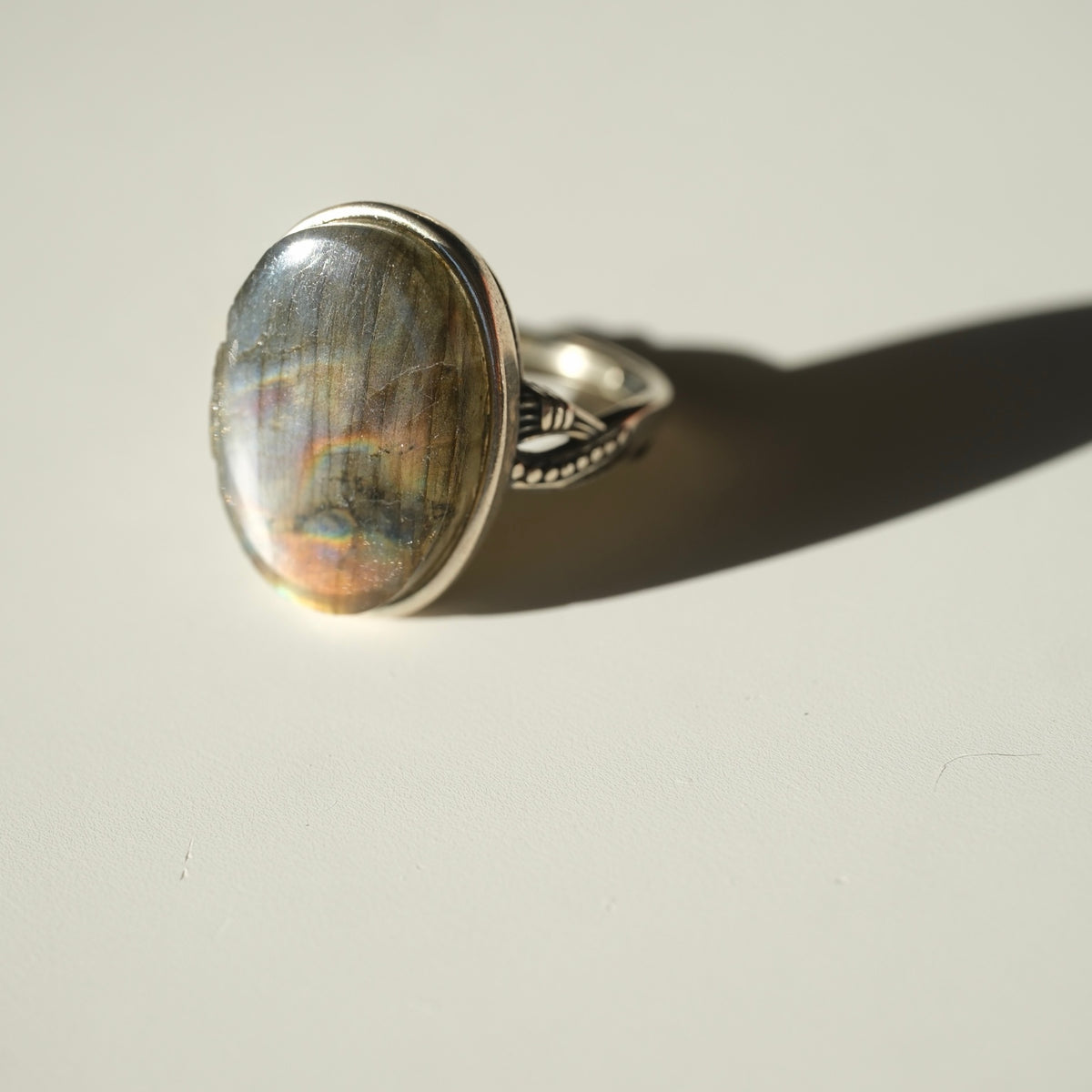 Oval Labradorite ring with silver-tone decorative band side view