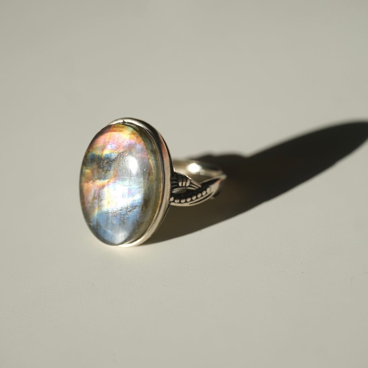 Labradorite ring with vivid blue and golden iridescence side angle