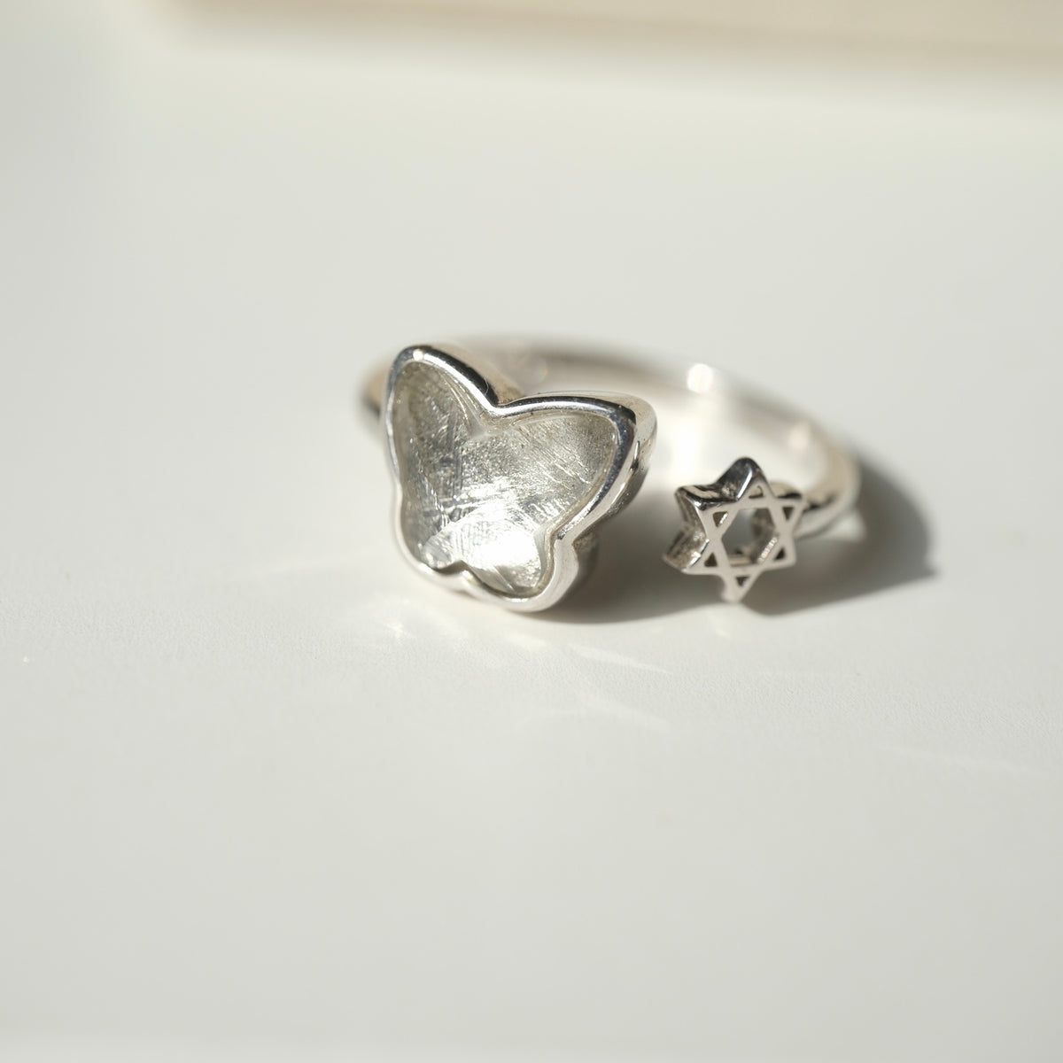 Angled view of the butterfly and star adjustable ring