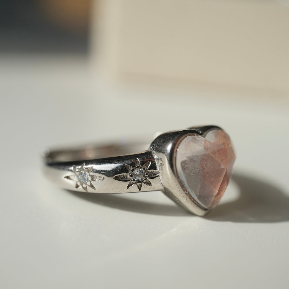Side view of the heart ring showing star details and clear accents
