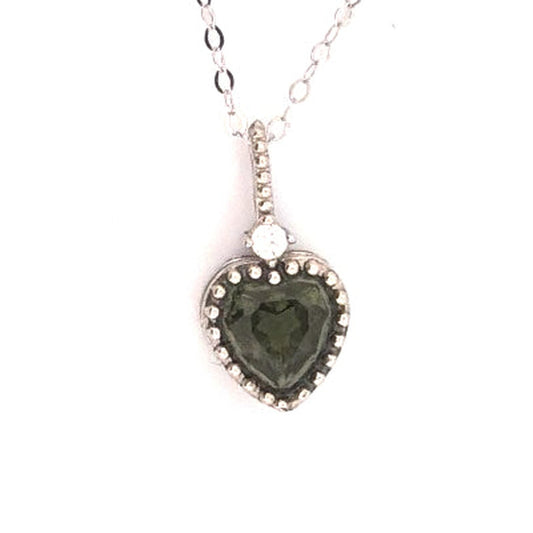Heart-shaped Moldavite pendant in S925 sterling silver, close-up on a white background