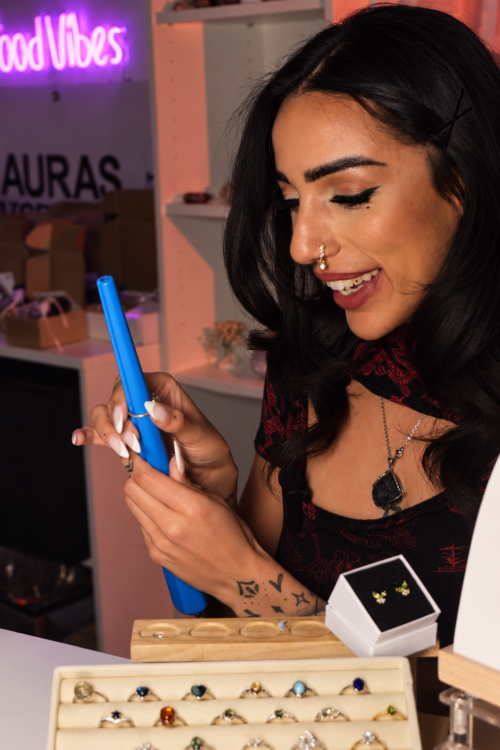 Beccs, founder of Auras Crystals, smiling while working with crystal jewellery