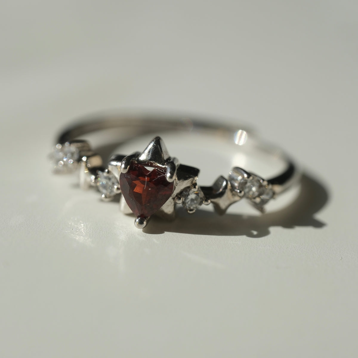 Garnet Star S925 adjustable ring with a red heart-shaped stone, silver star details and clear accent stones