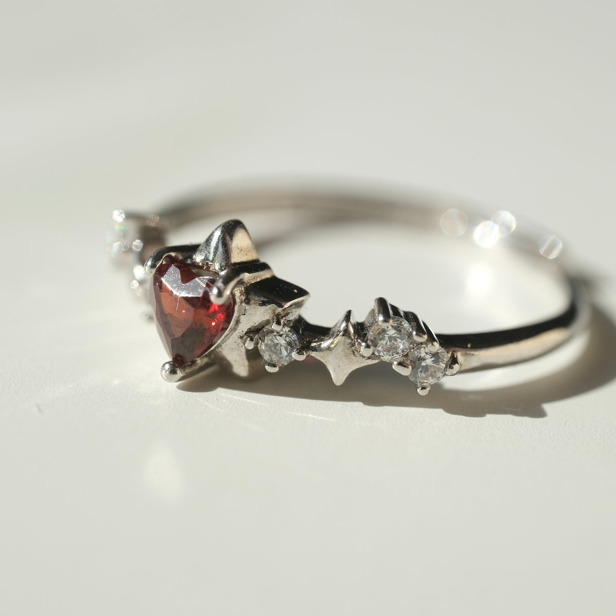 Garnet Star S925 adjustable ring with a red heart-shaped stone, silver star details and clear accent stones