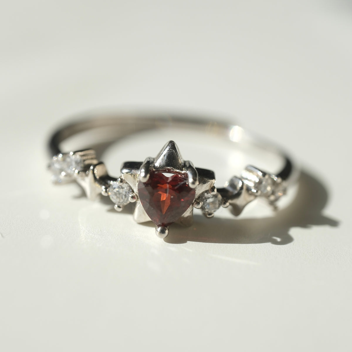 Garnet Star S925 adjustable ring with a red heart-shaped stone, silver star details and clear accent stones