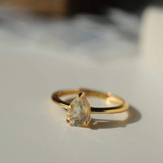 Libyan Desert Glass teardrop S925 adjustable ring with a faceted pale yellow stone and a slim gold-coloured band