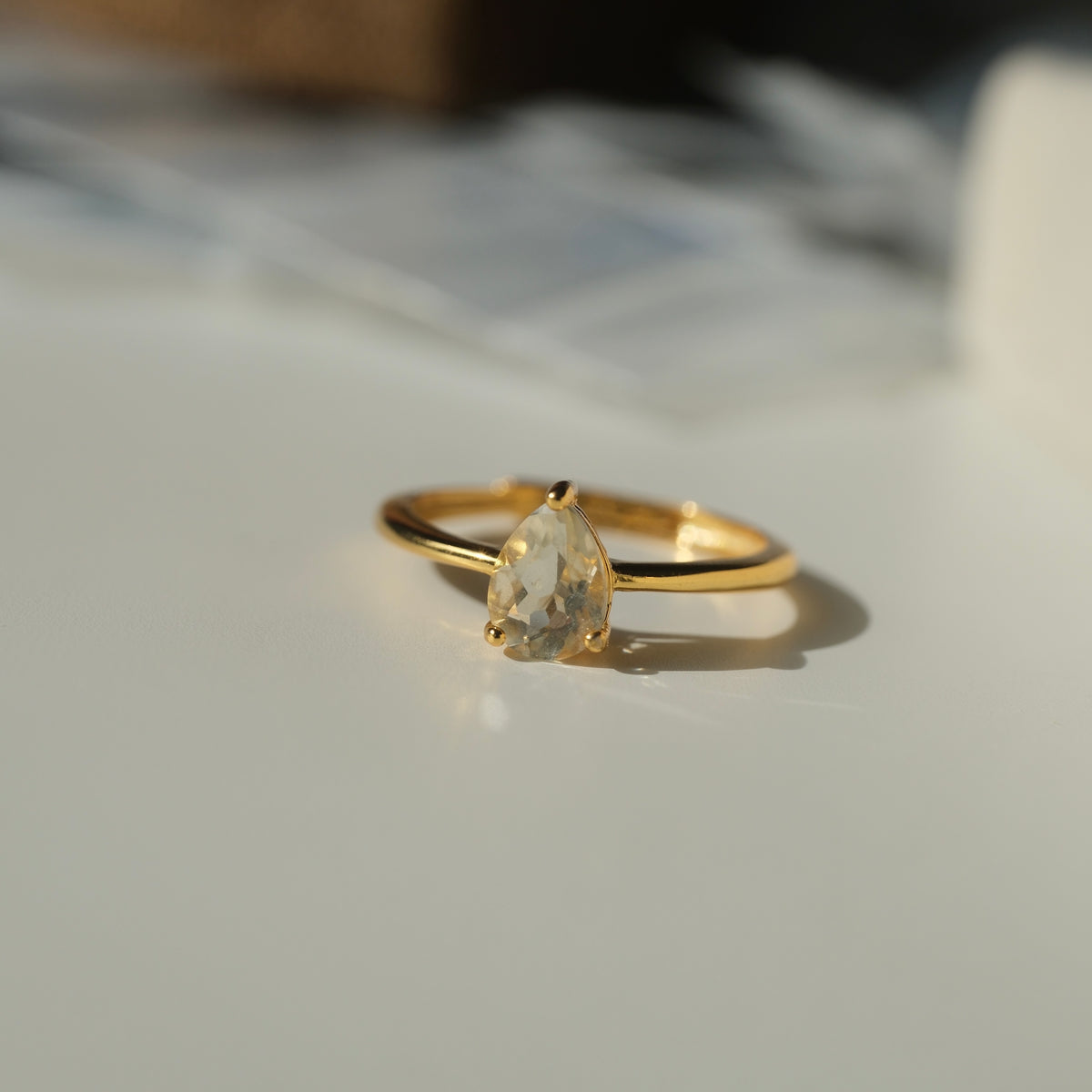 Libyan Desert Glass teardrop S925 adjustable ring with a faceted pale yellow stone and a slim gold-coloured band