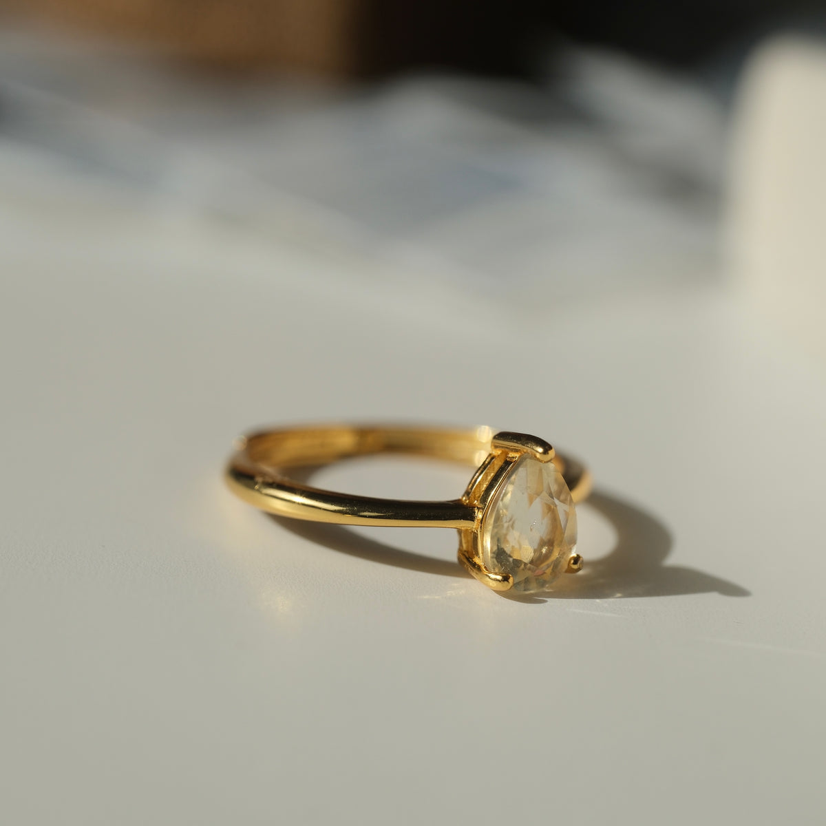 Libyan Desert Glass teardrop S925 adjustable ring with a faceted pale yellow stone and a slim gold-coloured band
