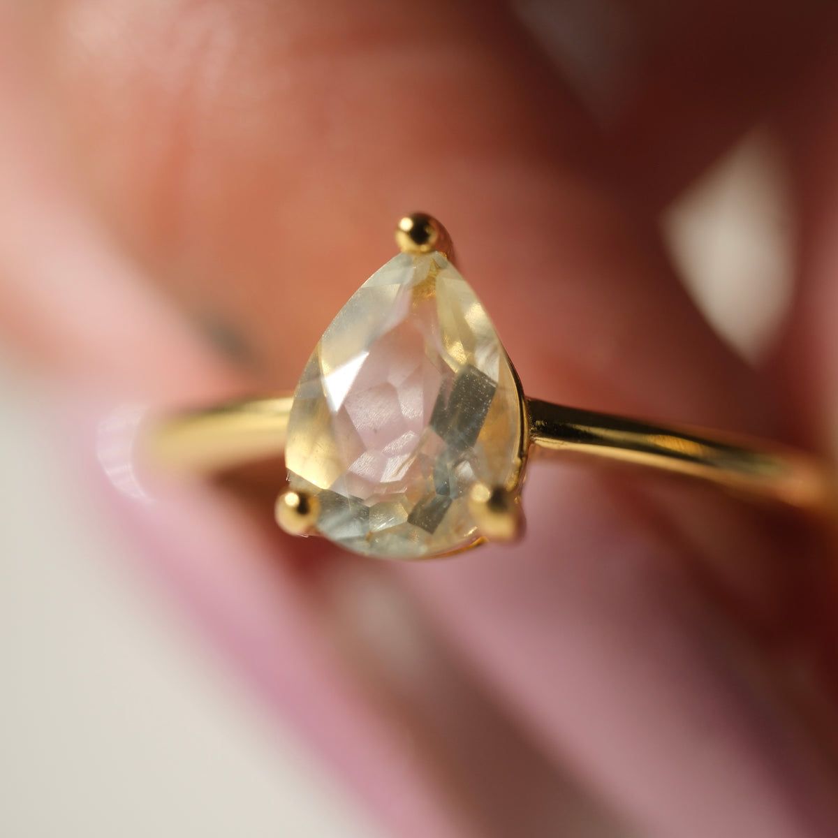 Libyan Desert Glass teardrop S925 adjustable ring with a faceted pale yellow stone and a slim gold-coloured band