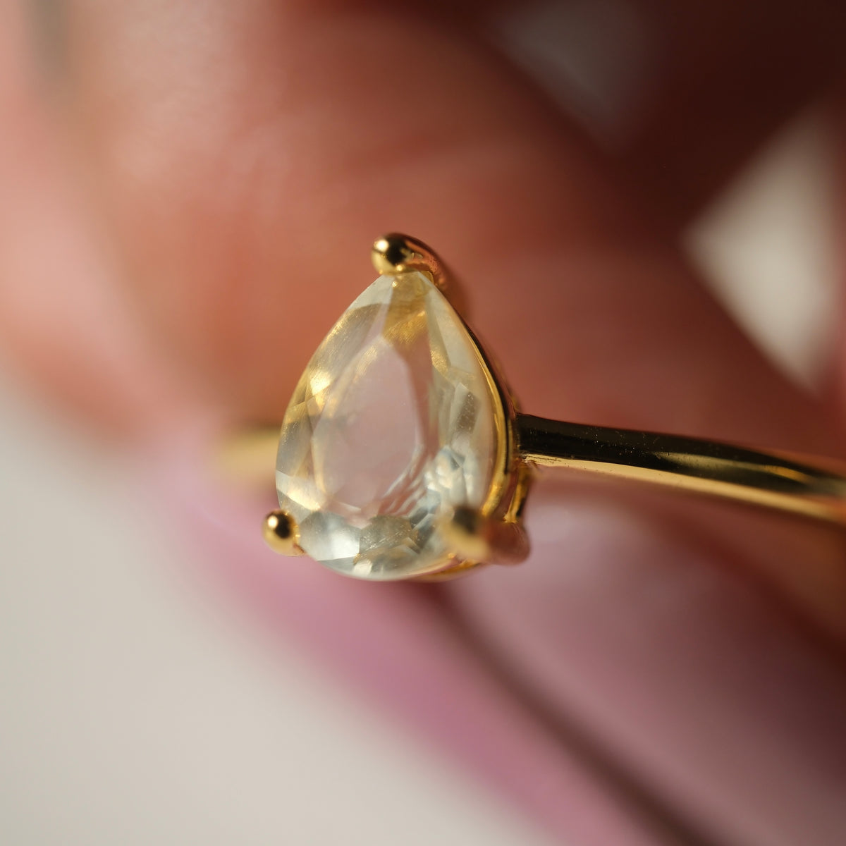 Libyan Desert Glass teardrop S925 adjustable ring with a faceted pale yellow stone and a slim gold-coloured band