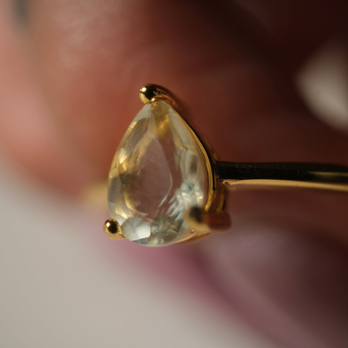 Libyan Desert Glass teardrop S925 adjustable ring with a faceted pale yellow stone and a slim gold-coloured band