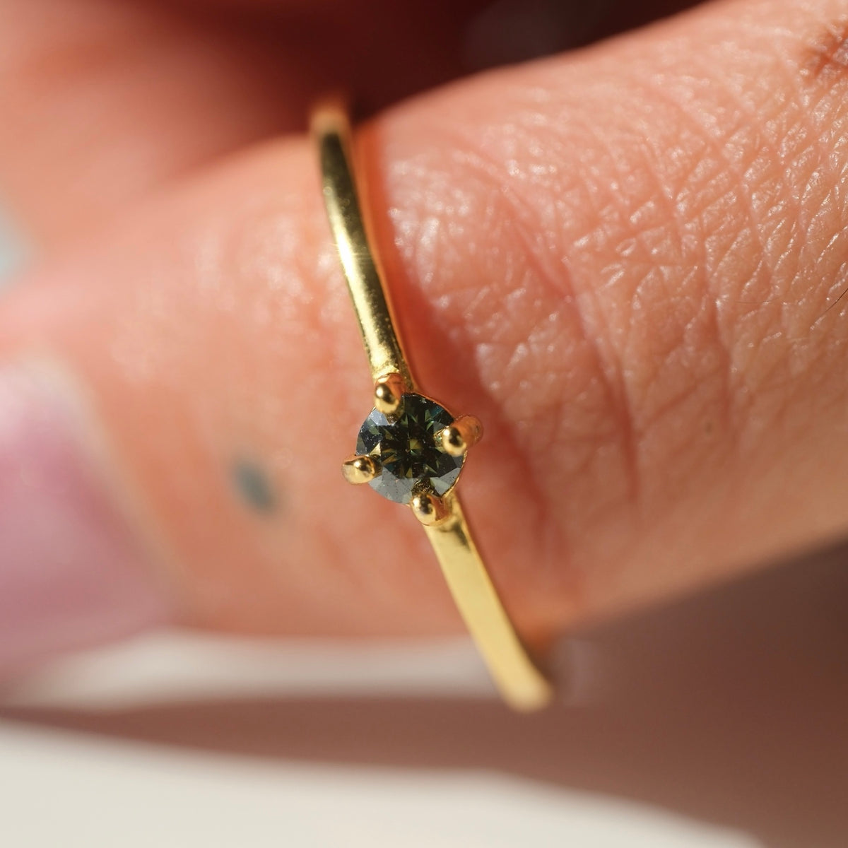 Green Moissanite ring worn on hand