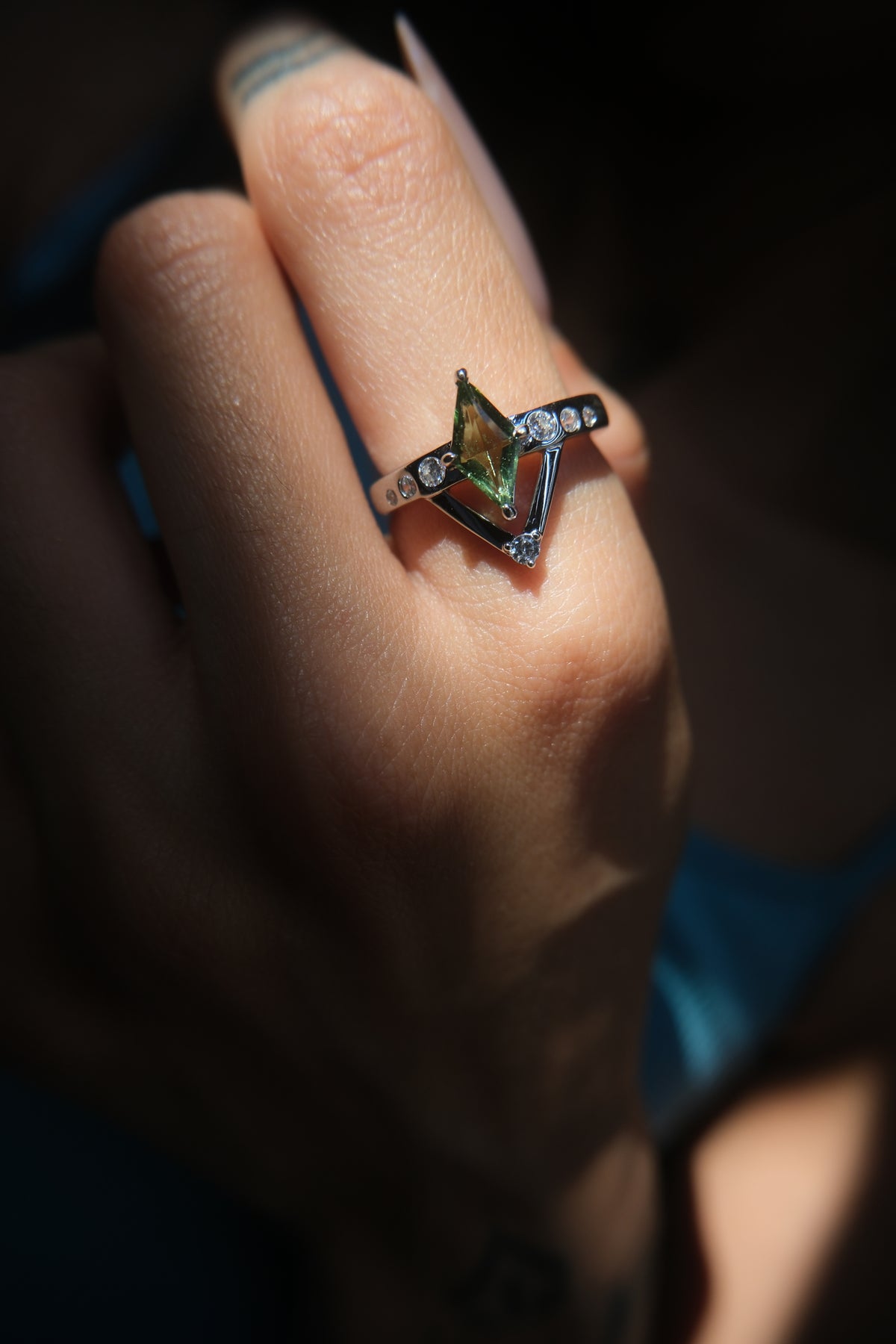 Moldavite sterling silver Intention Ring worn on hand, showing its scale and pointed design