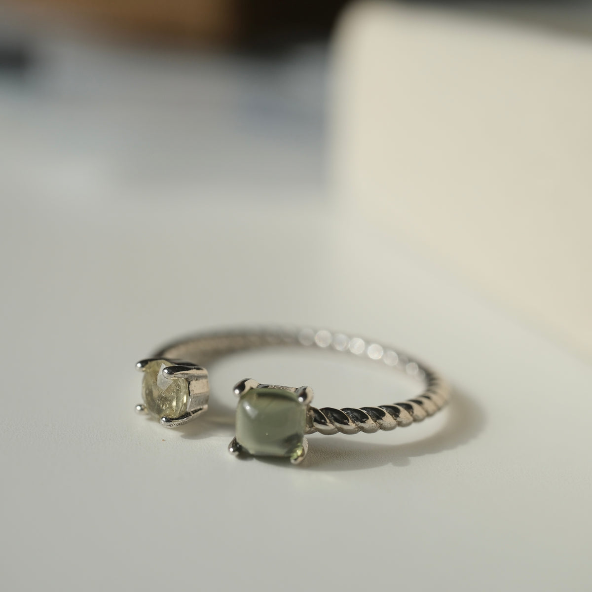 Moldavite and Libyan Desert Glass S925 adjustable ring with two stones in an open setting and a twisted silver band