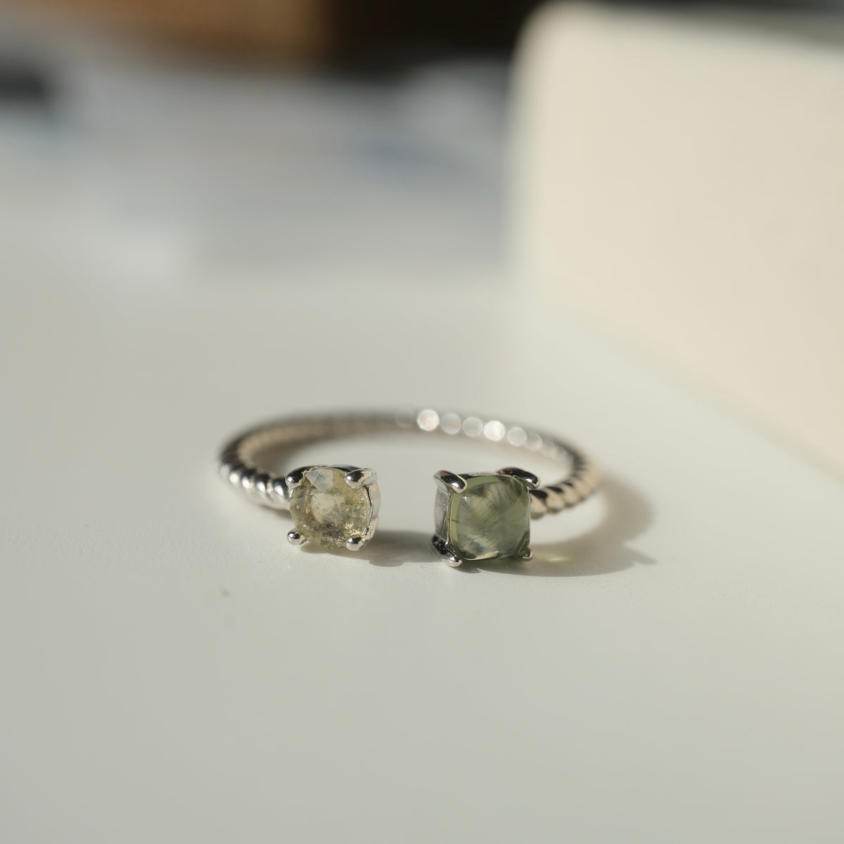 Moldavite and Libyan Desert Glass S925 adjustable ring with two stones in an open setting and a twisted silver band