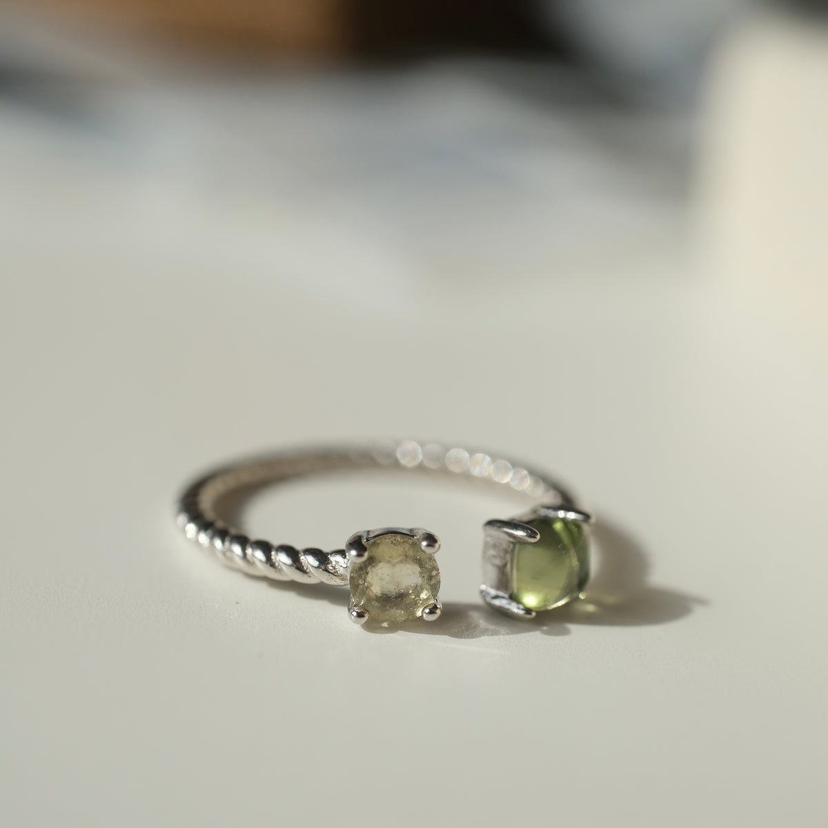 Moldavite and Libyan Desert Glass S925 adjustable ring with two stones in an open setting and a twisted silver band