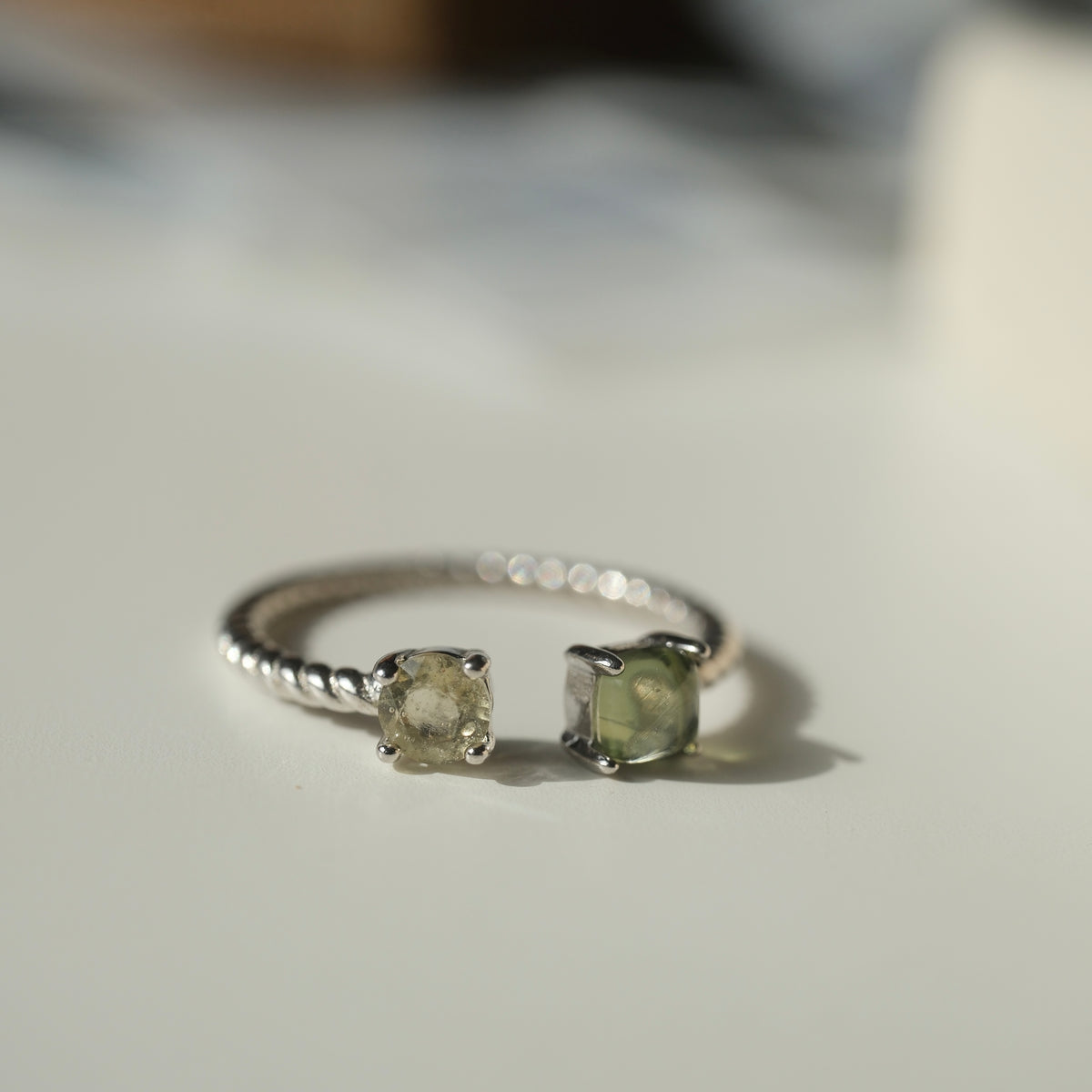 Moldavite and Libyan Desert Glass S925 adjustable ring with two stones in an open setting and a twisted silver band