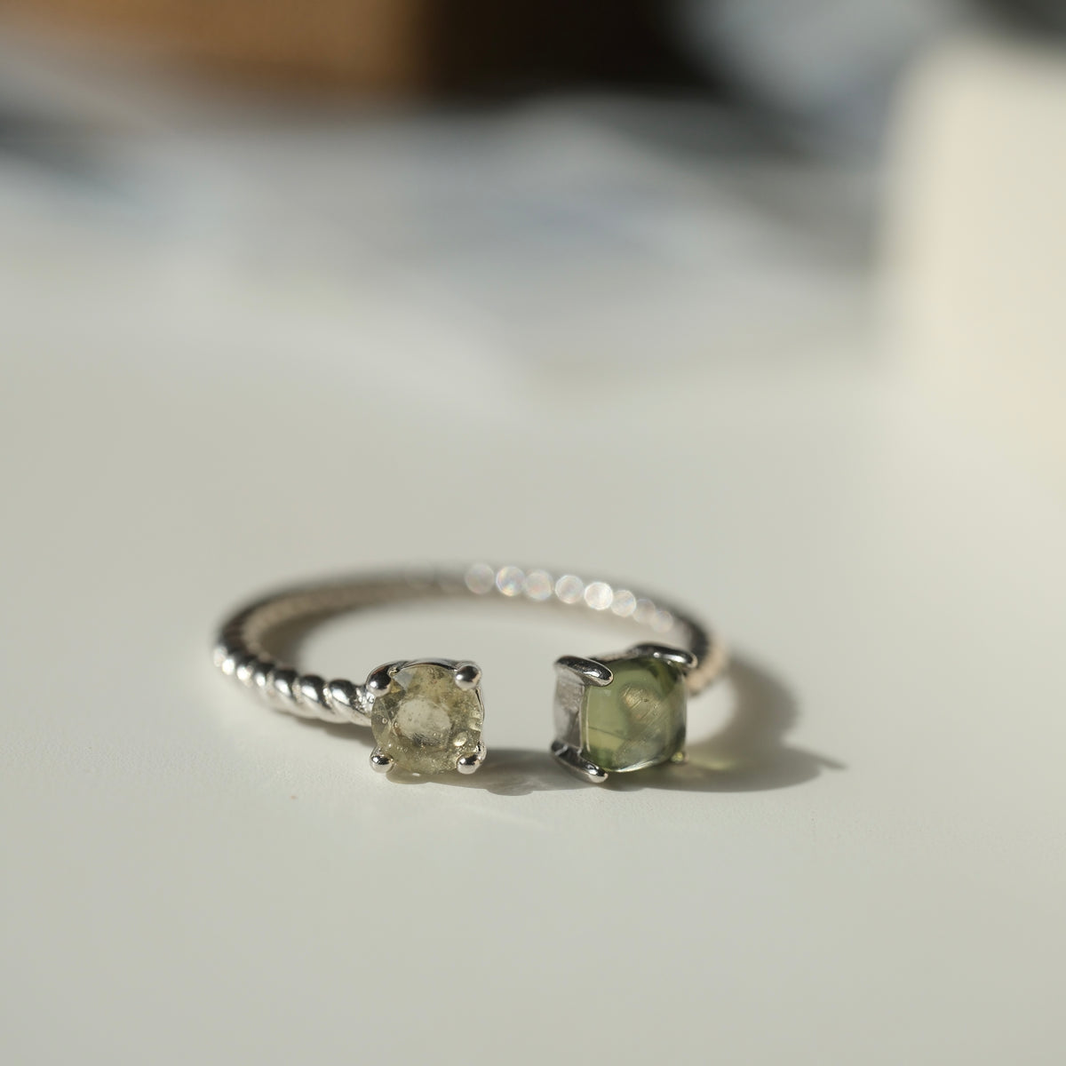 Moldavite and Libyan Desert Glass S925 adjustable ring with two stones in an open setting and a twisted silver band