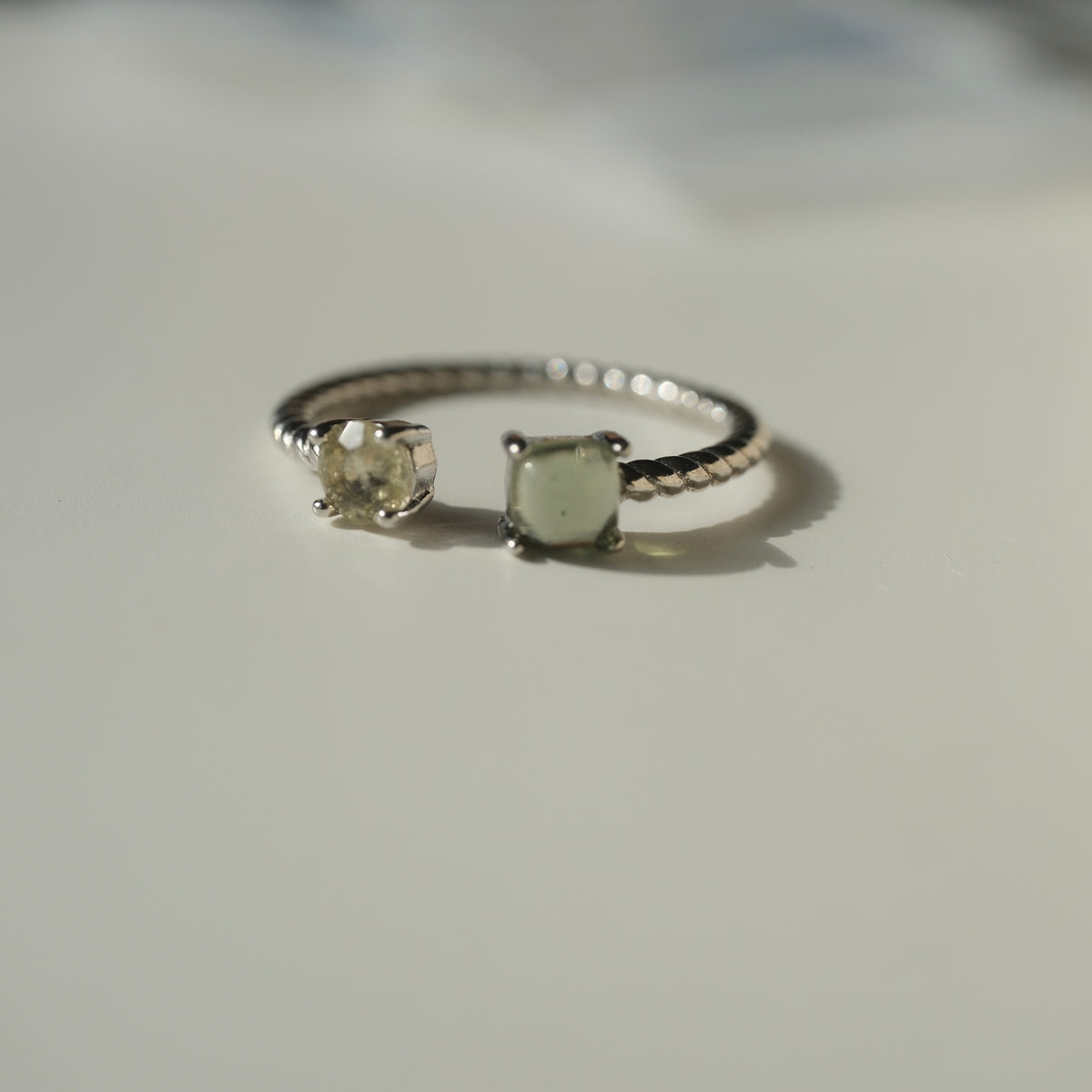 Moldavite and Libyan Desert Glass S925 adjustable ring with two stones in an open setting and a twisted silver band
