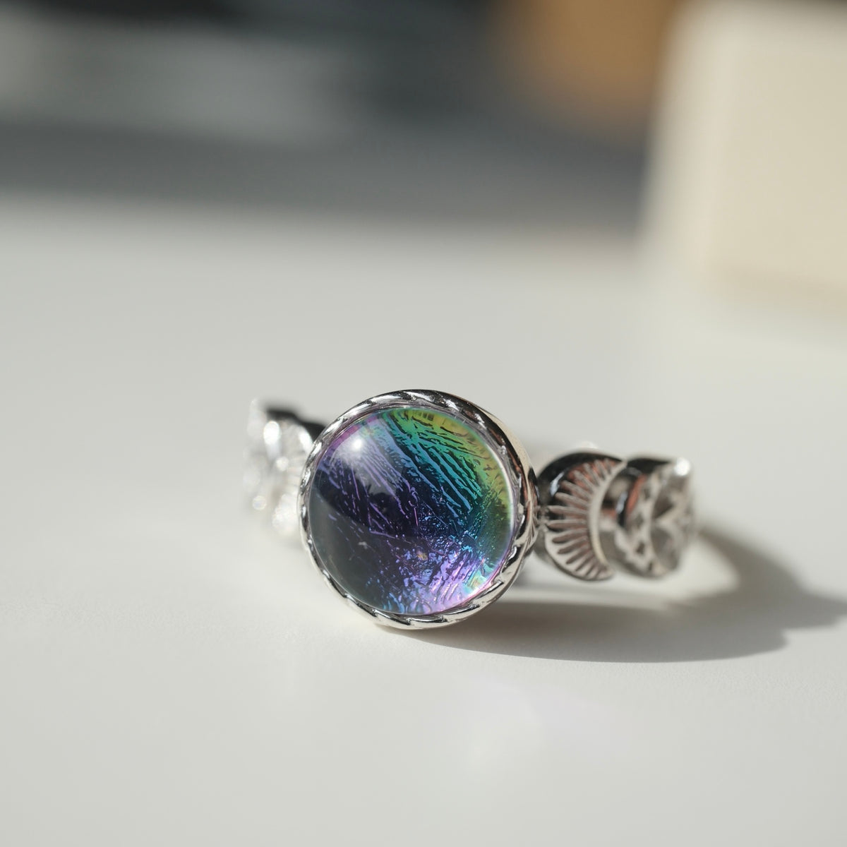 Muonionalusta moon and star ring showing blue purple and green reflections