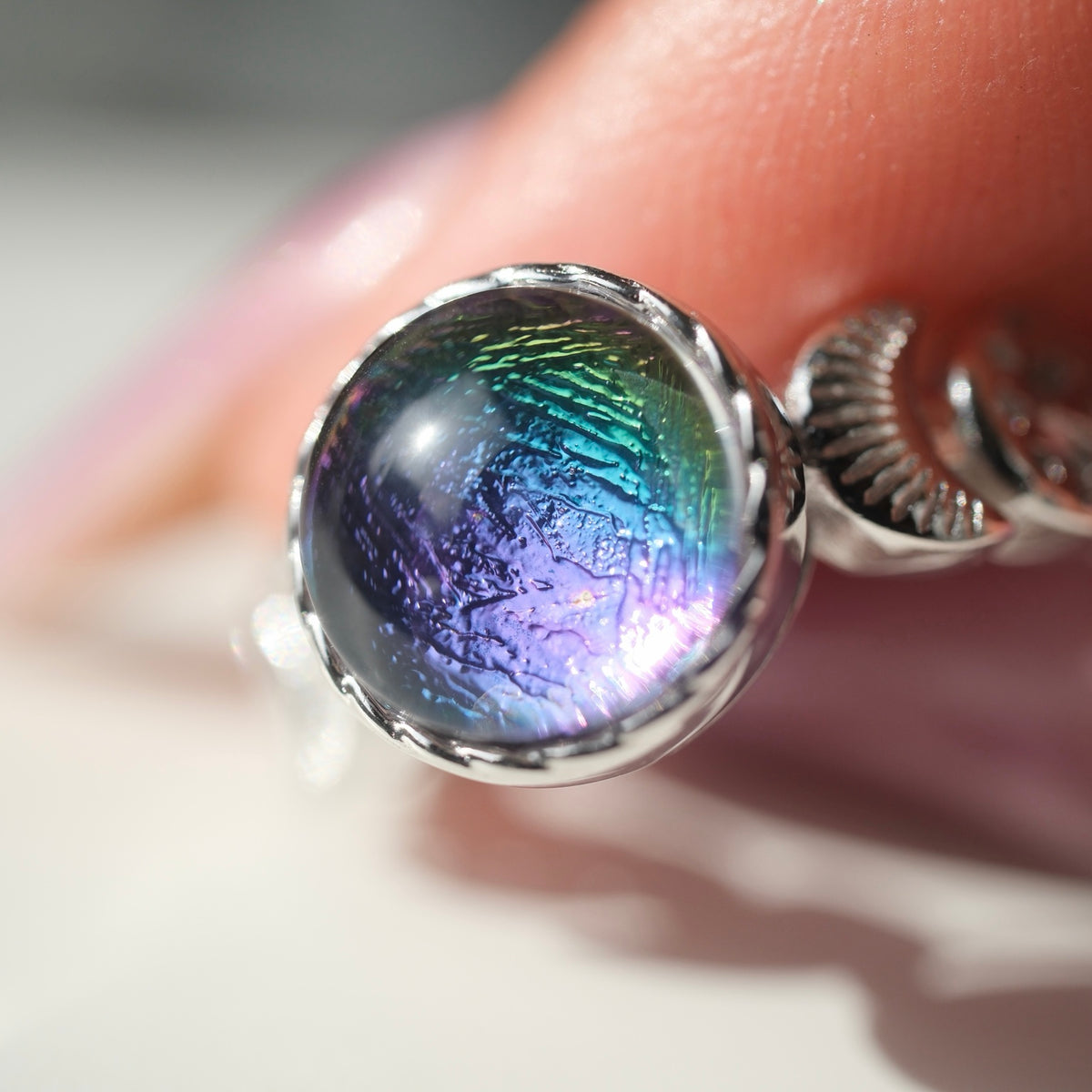 In-hand close-up showing colourful reflections and centre pattern