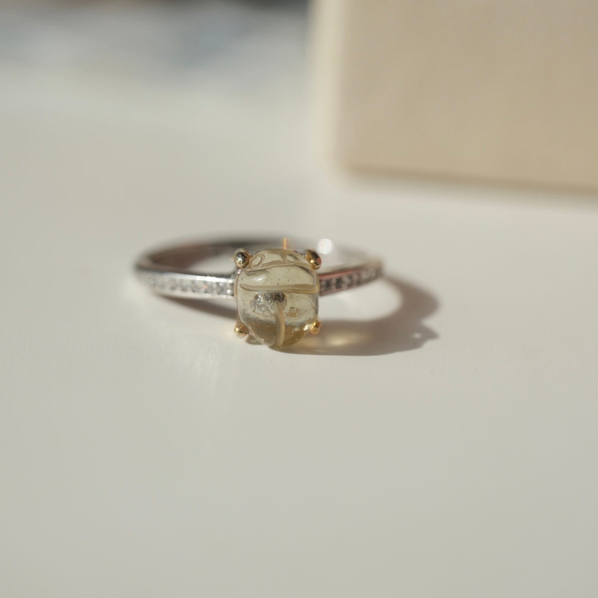 Small scarab ring side view with clear accents